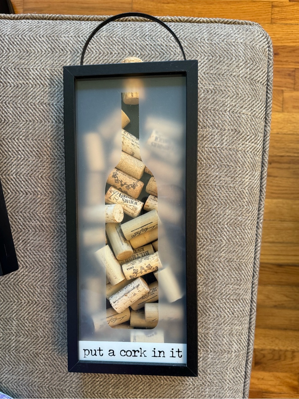 ‘Put a cork in it’ wine shaped black wall display with used assorted corks